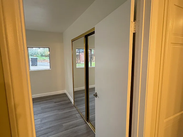 Turning left into Master Bedroom, mirrored sliding door closet visible. Door just next to entry to MB is the linen closet