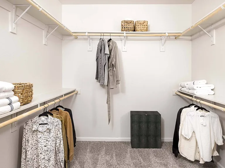 Keep your wardrobe organized in your expansive walk-in closet with ample storage space.