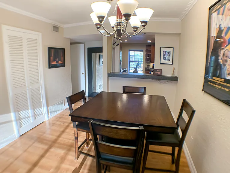 The dining area connects to the kitchen with an open bar, a perfect layout for hosting.