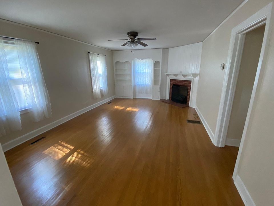 Roomy living room with gas logs.