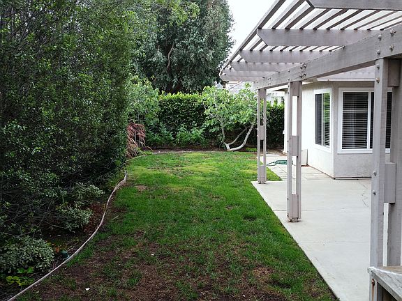 back yard with large trellised patio