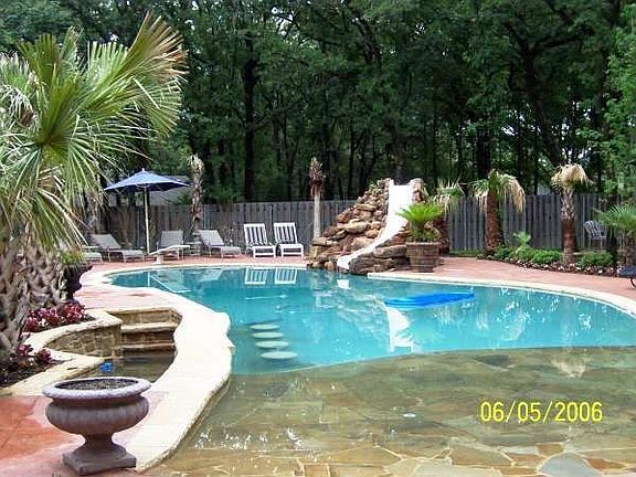 Beach entry pool with swim up barstools and walkdown serving area