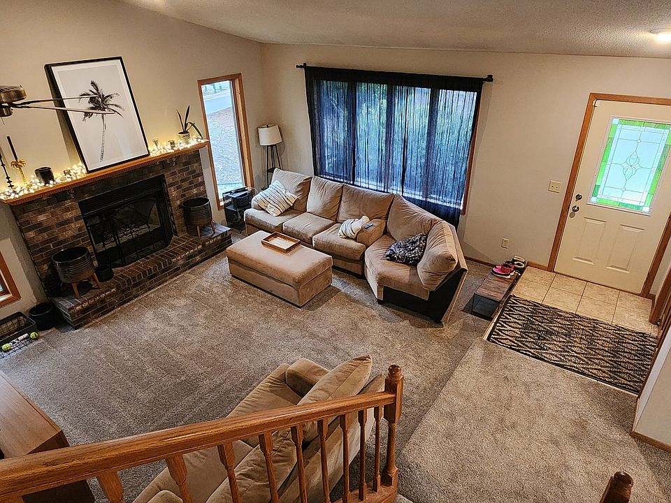 View of front door and living room from the upstairs hallway.