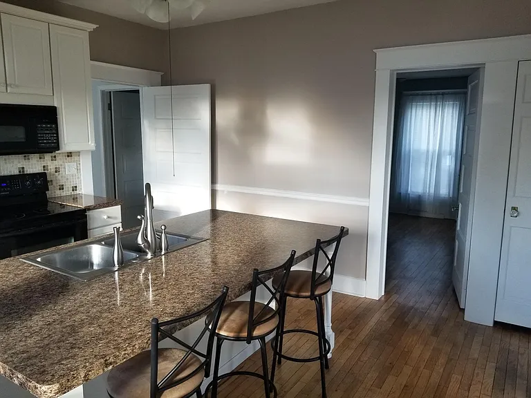 Kitchen, view into bedroom 1