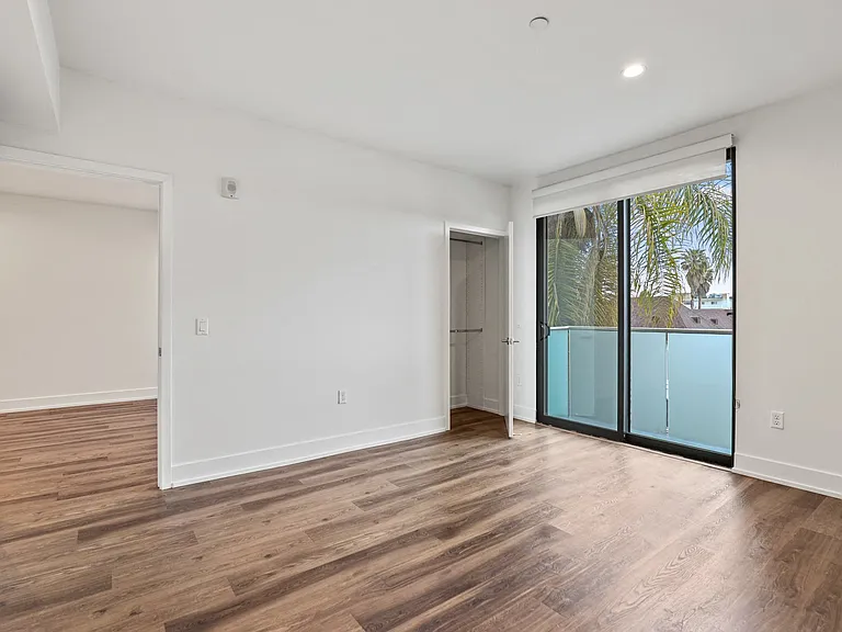 Bedroom with Recessed Lighting, Vinyl Flooring, and Balcony