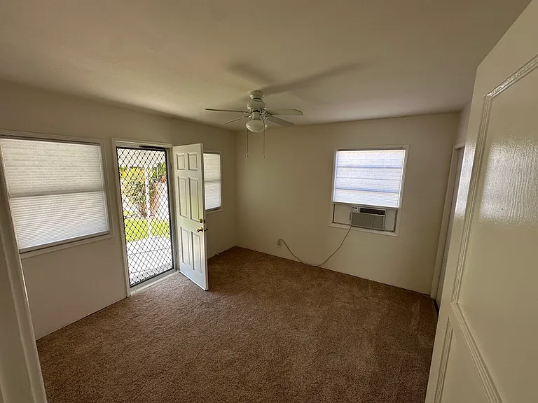 Bedroom 2 with lockable screen door, ceiling fan and large closet