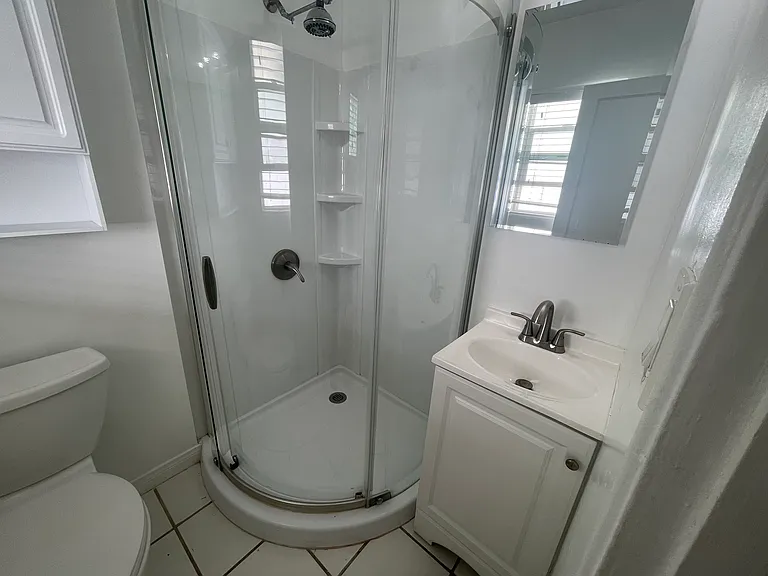 Newer shower with vanity.