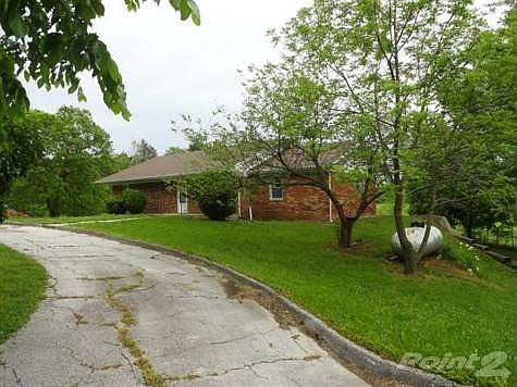 Brick home with circle driveway, huge sunroom on south side of home over looking small branch and Wolf creek with 23 acres.