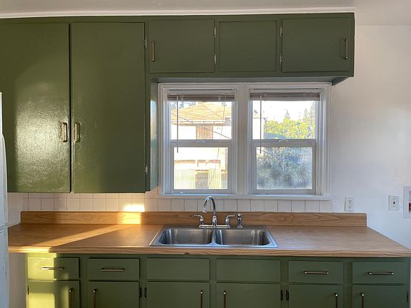 Newly painted kitchen cabinets and sink fixtures.