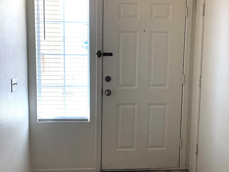Front door entrance with side window.