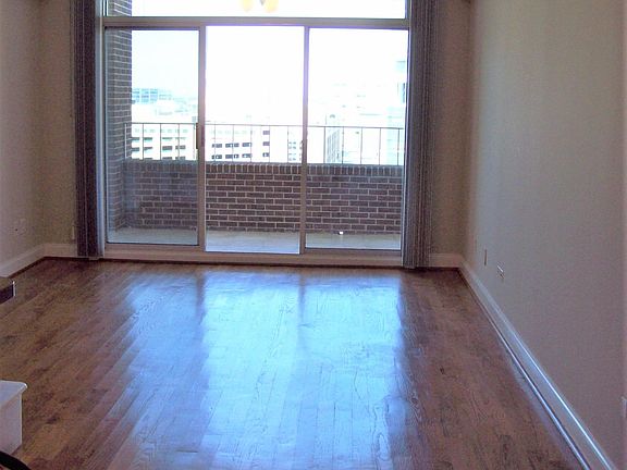 living area facing patio. notice the nice wooden floors.