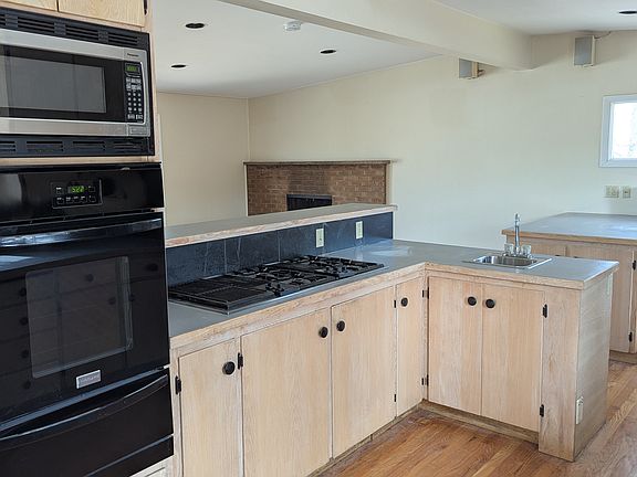Kitchen and adjacent dining room with fireplace