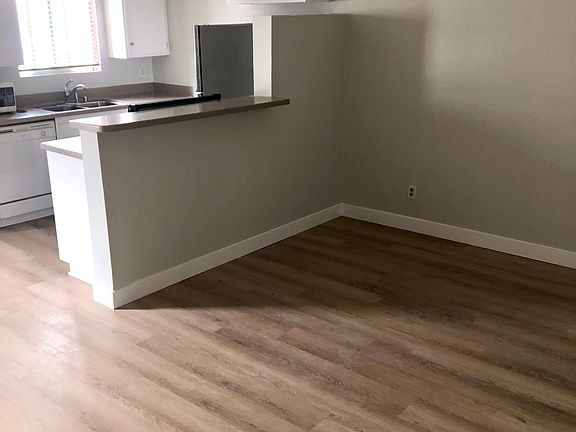Living area with open kitchen/bar, brand new luxury vinyl flooring