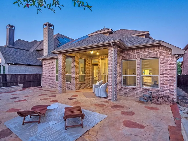 A charming patio with stylish wooden lounge chairs, inviting for relaxing evenings outdoors.