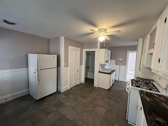 Large eat-in kitchen with gas stove, refrigerator, and pantry.