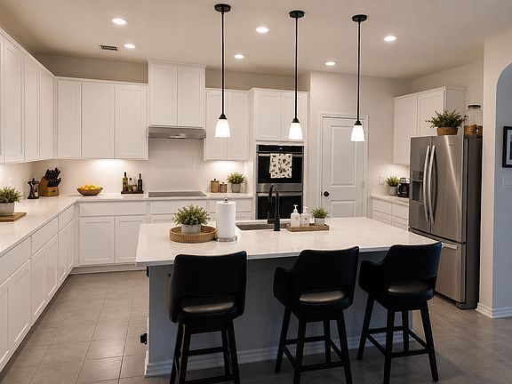 Bright kitchen with Double ovens, glass cooktop and dine at bar top!