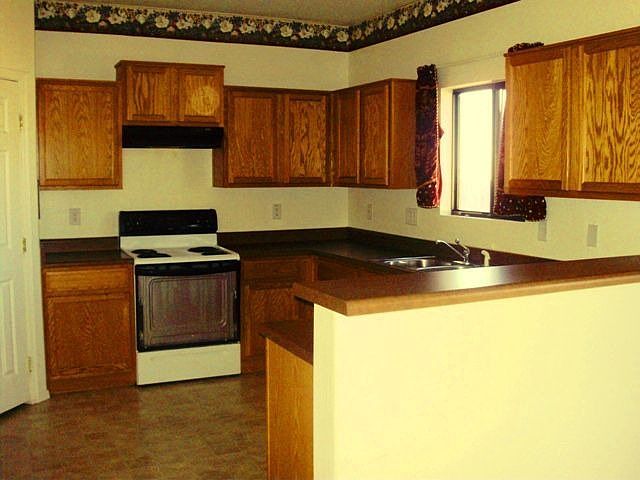 Large open kitchen with breakfast bar and pantry