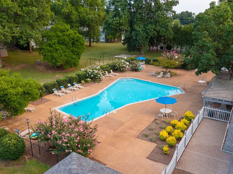 Lushly-Landscaped Pool Area with Seating