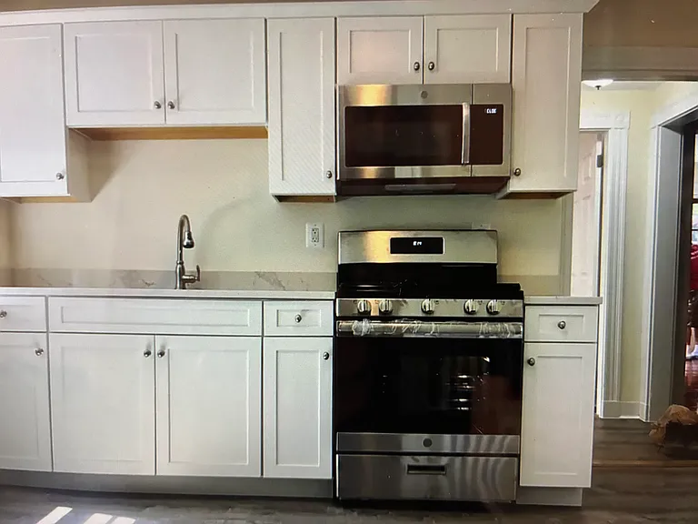 This spacious corner unit has a gourmet kitchen with granite countertops, custom cabinets, built-in microwave oven and stainless steel range.