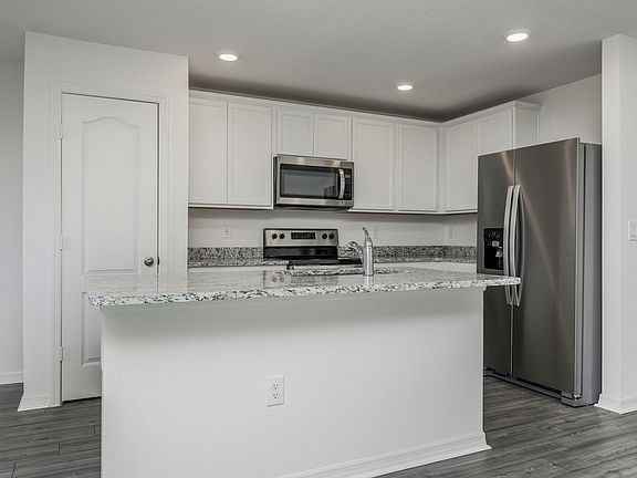 The kitchen is chef-ready with stainless steel appliances