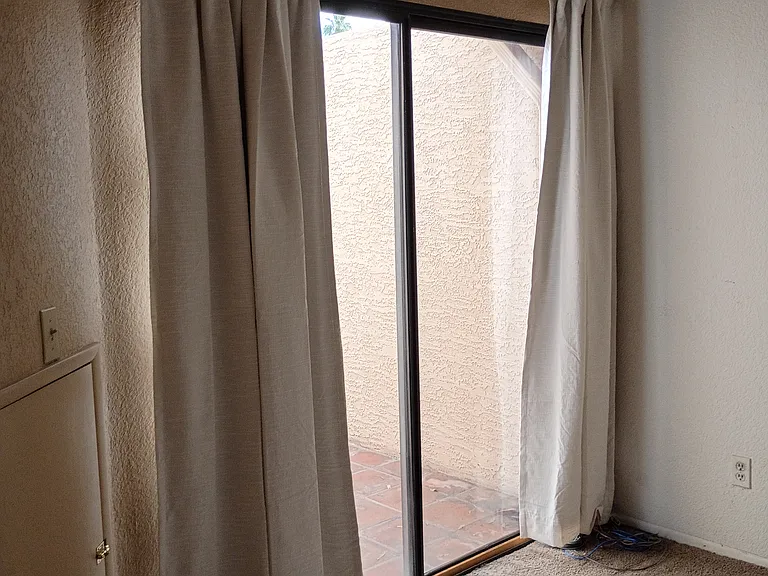 Bedroom sliding glass door that leads to front patio