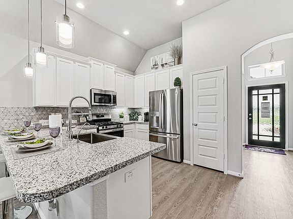 Kitchen is located just off foyer