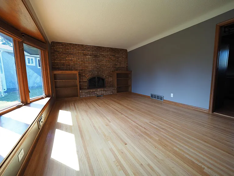LIVING ROOM with fireplace and built in book shelves.