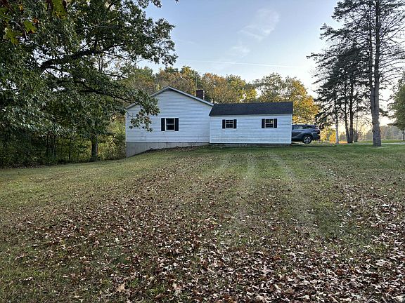 Side of house with detached garage.