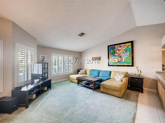 Large Living Room with Plantation Shutters to control the light and sunshine. Nice vaulted ceilings for the feel of eligance.