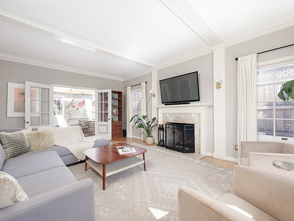 10'' ceilings in this formal living room is perfect for entertaining friends and family around the holidays with real wood burning fireplace