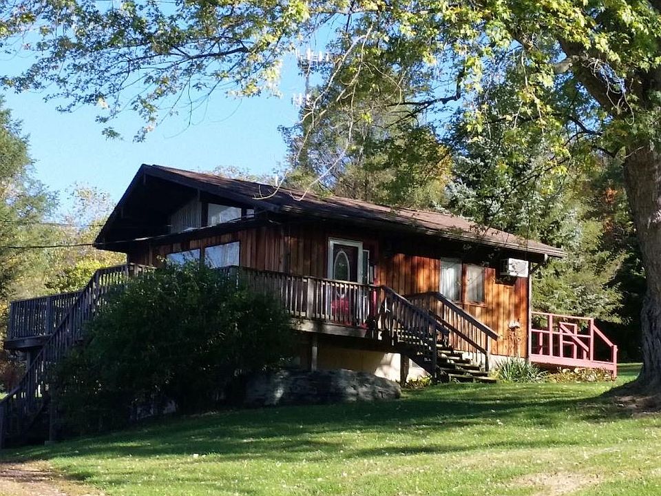 Front of home is covered in windows with large deck