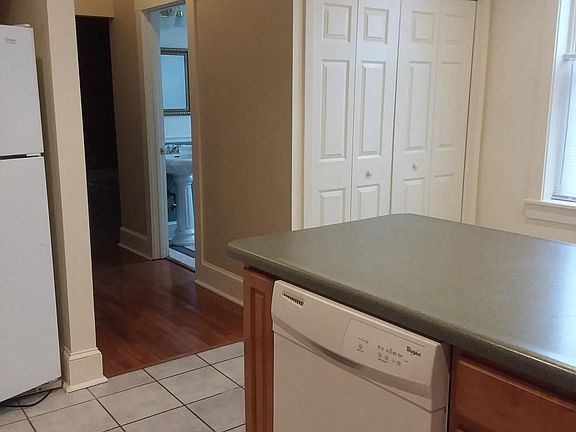 Kitchen shows appliances and laundry closet