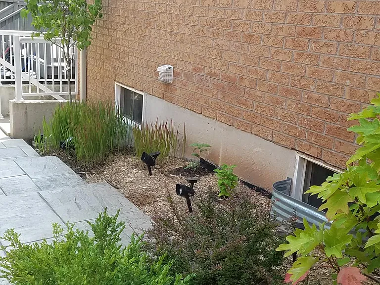 Patterned Concrete high end beautiful staircase/pathway leading to basement. Professionally landscaped with high end solar lights (right side view). Motion sensor floodlights are also installed in the pathway in addition to a a dozen solar lights to provi
