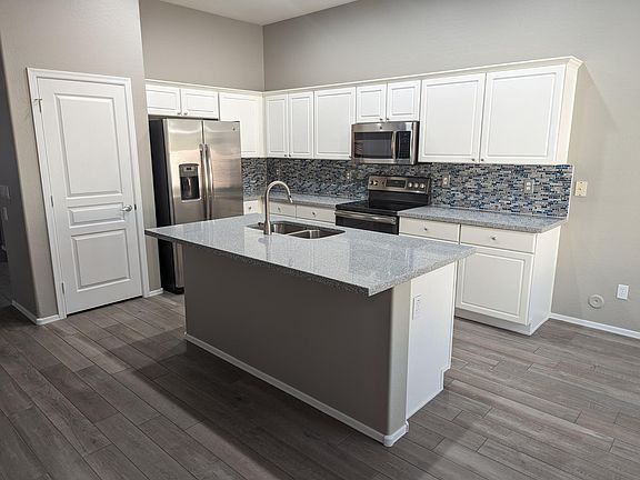 Kitchen with granite counters and tile backsplash
