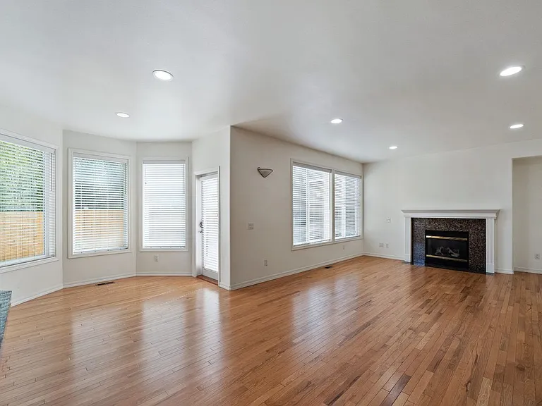 Family and dining room with hardwood floor