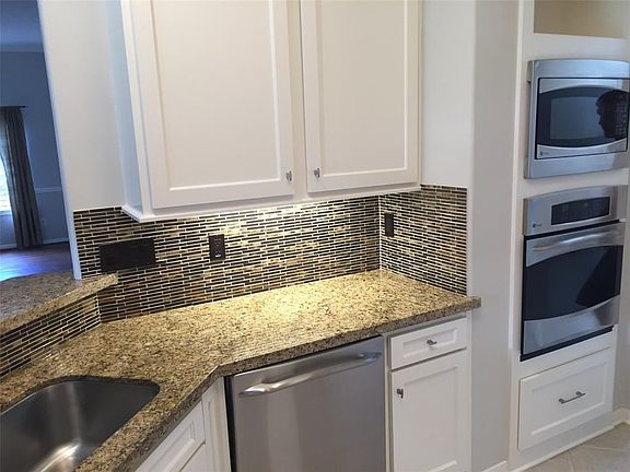 Terrific lighting in this kitchen, with modern backsplash an