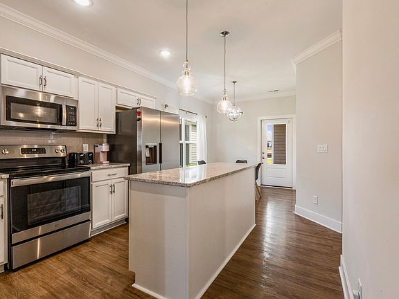 Kitchen comes with basic cooking essentials, dishwasher, microwave, and stove.