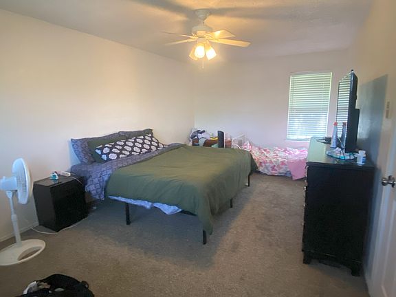 The upstairs primary bedroom is quite large and offers windows on both sides of the room