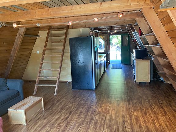 Nice sized living room with a bookcases shelves in Aframe walls