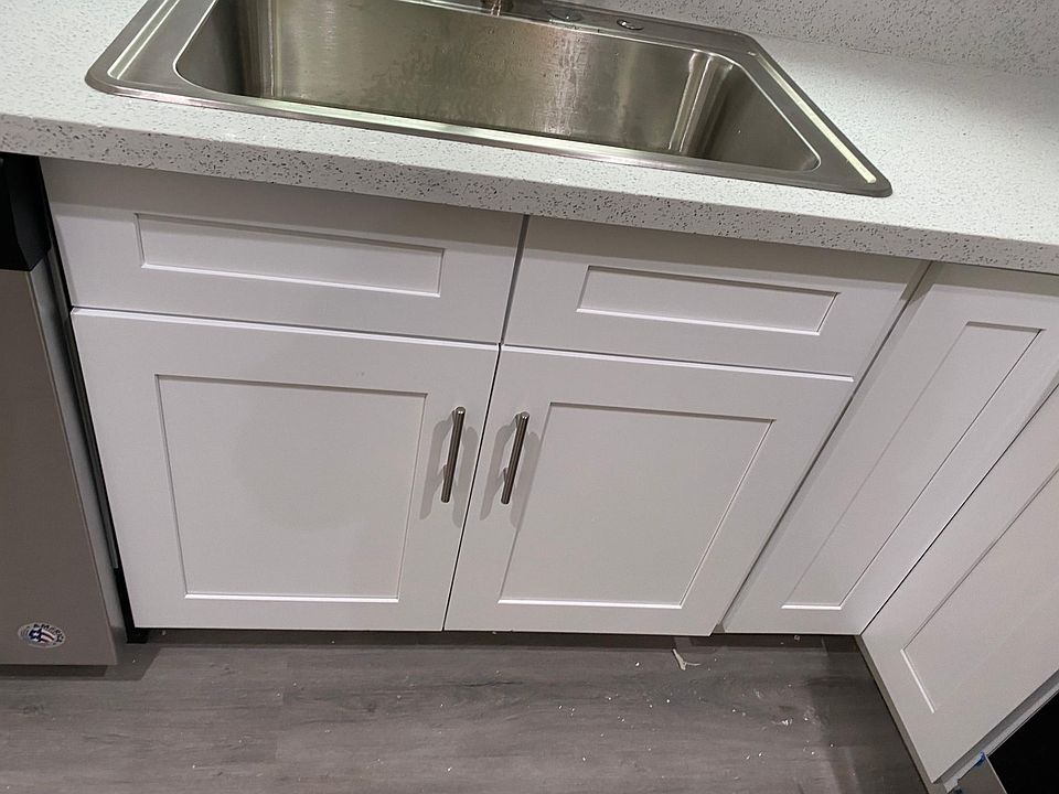 White Shaker cabinets with slow closing drawers.