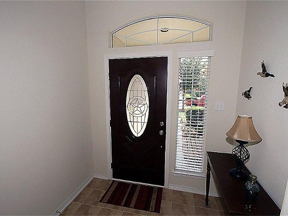 Welcoming entry with tile floor. Beautiful new fiberglass front door and triple locking security gla