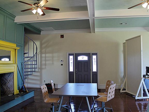 Steel beams & wood burning fireplace.