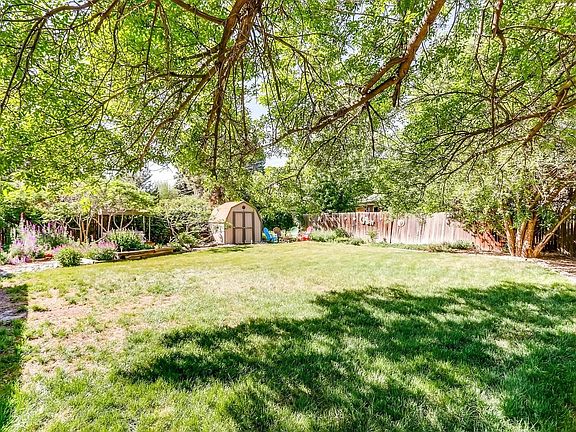 You'll enjoy the water feature, conversation area around a fire, raised flower beds and the big storage shed!