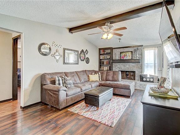 Living Room has beautiful laminate wood floors, vaulted ceiling, built-ins and Fireplace.