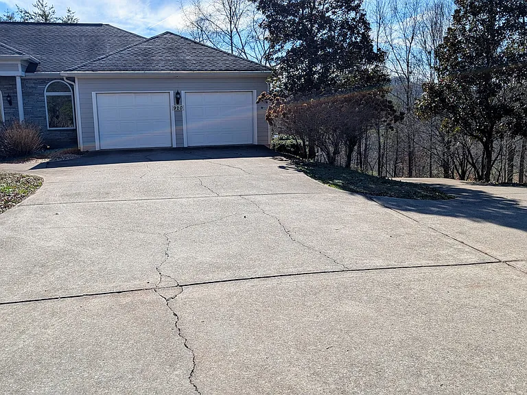 Front of house (upper level) occupied by our mother/mother-in-law. Driveway for apartment in on the right side of the picture.