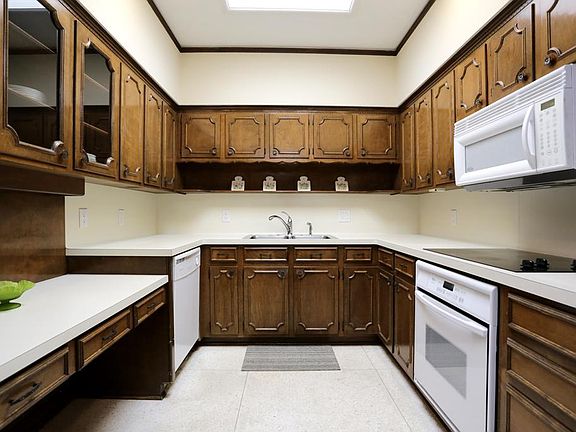 Kitchen has ample cabinet & counter space for food prep as well as a built-in desk space with glass 