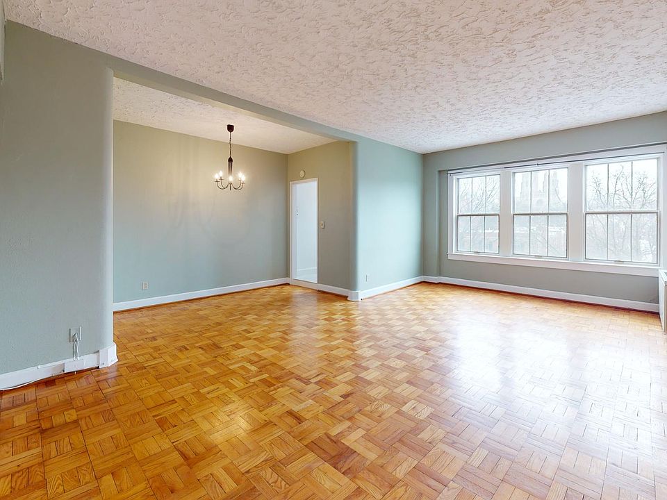 View upon entry into apartment showing living room and dining area and opening to kitchen
