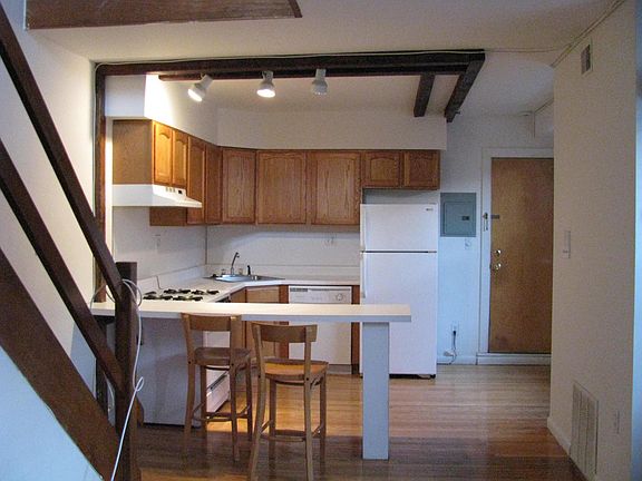 Kitchen w/ breakfast bar, Entrance to Apt right of Frig.  (l