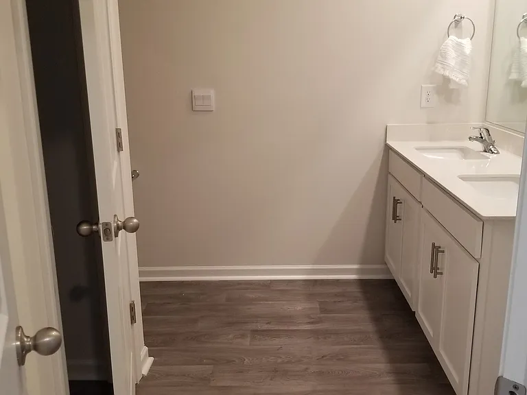 His & Hers sinks and storage closet in private bathroom