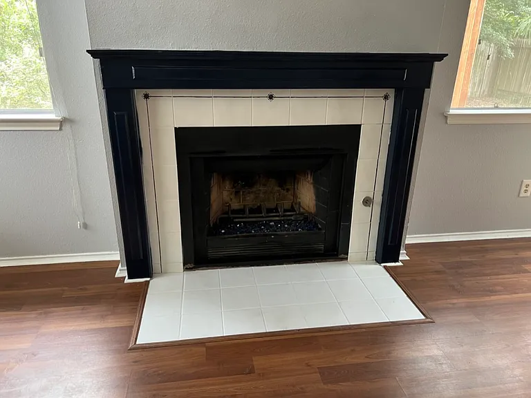 Fireplace is decorative and this is the current painted effects of the surround. Previous pictures show different color, but it has been painted.